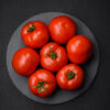 Delicious fresh juicy tomatoes on a dark concrete background Pomodoro Moskvich semi